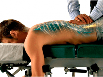 Profissional de quiropraxia realizando atendimento na Clínica Sphera